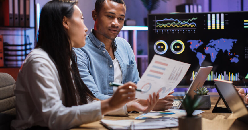 African man and asian woman having paperwork at office